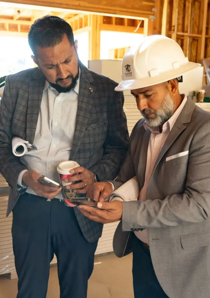 President and Co-Founder, Prem Dhoot with the Director of Construction, Jose De La Cruz, looking over details during the building of a custom new home in the San Francisco Bay Area, California